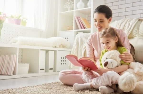 Maman montrant un livre à sa fille
