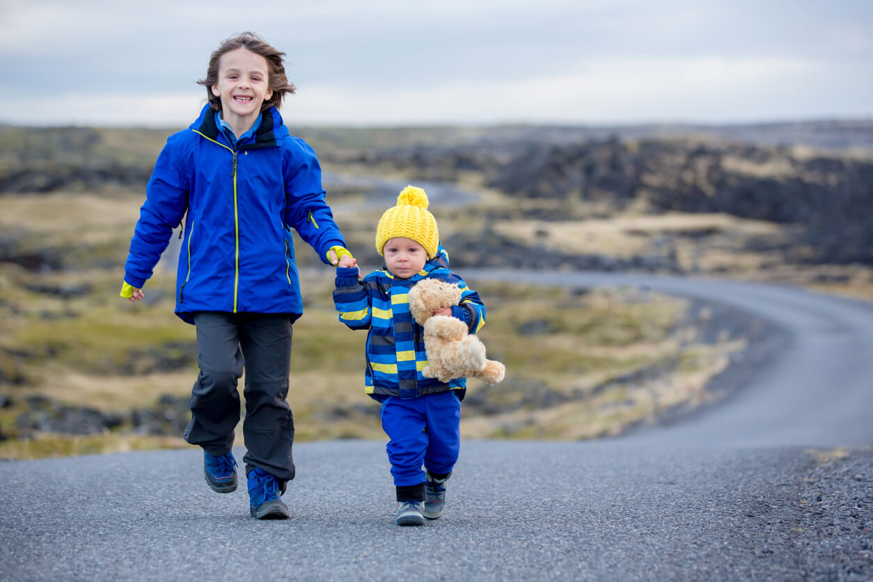 Deux enfants qui se promènent sur une route en Islande.