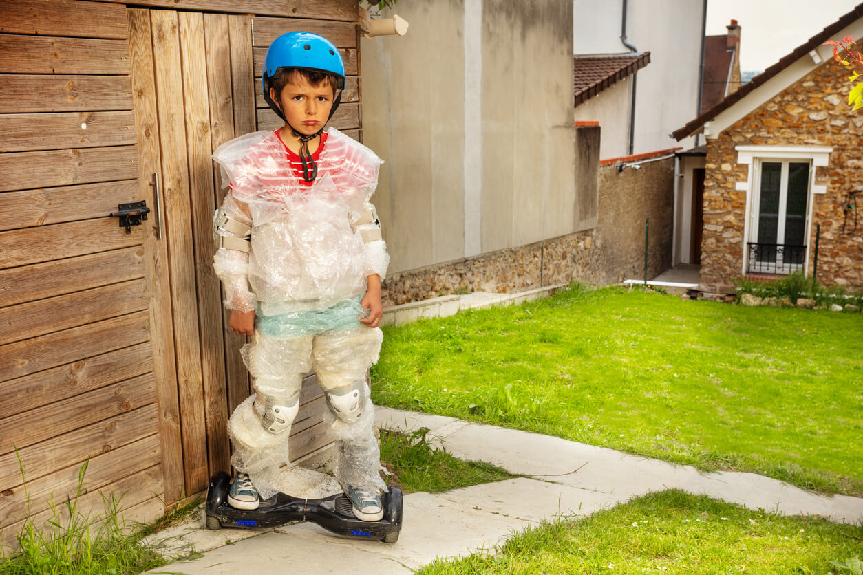 A child wrapped in bubble wrap and wearing a helmet while skating.