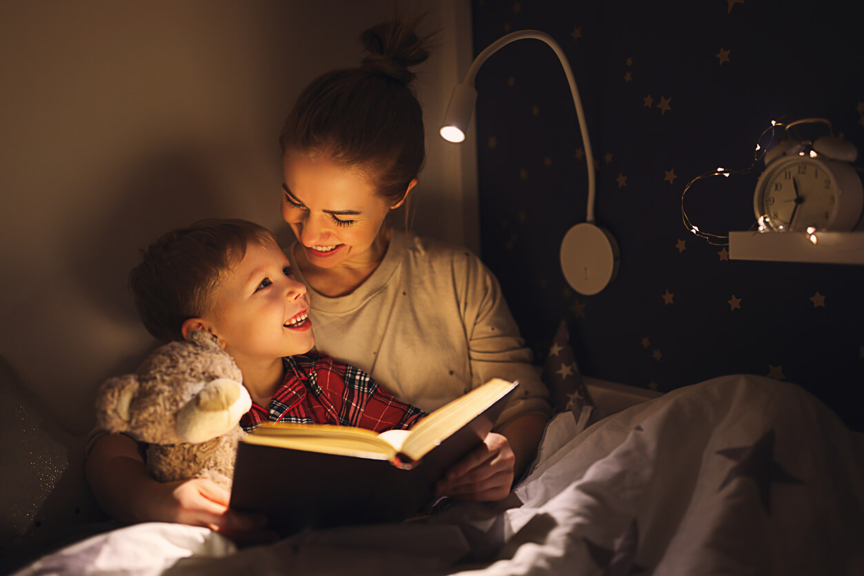 A mother reading to her son at bed time.