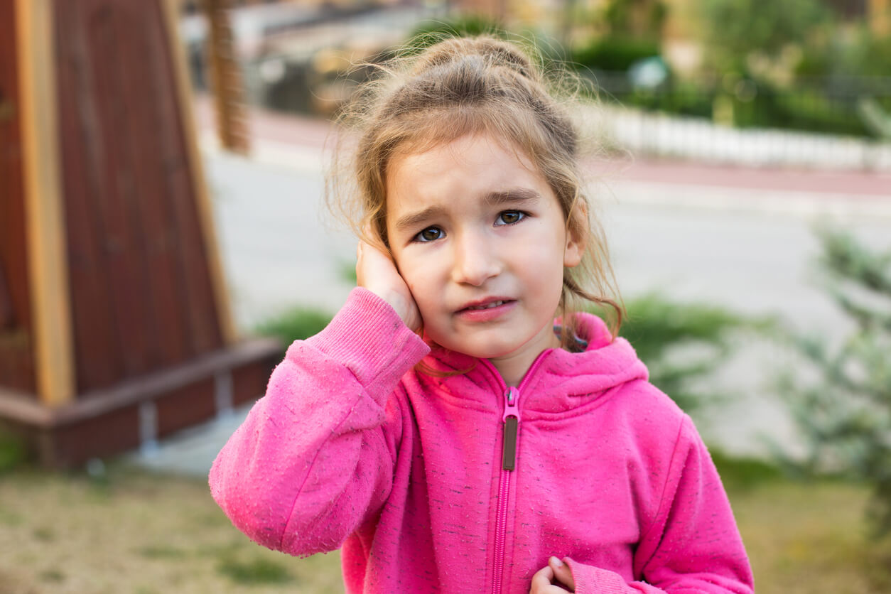 petite fille tient son visage mal aux oreilles détresse pleurant