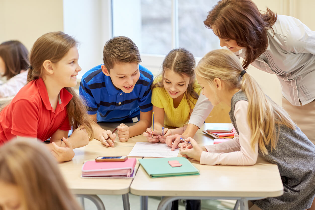 Children working on a group project at their desks.