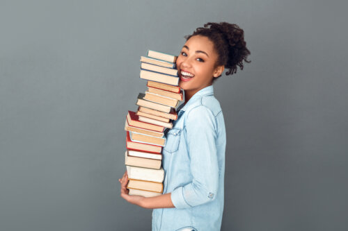 joven camina con una pila de libros concepto de lectura afan hobbie pasatiempos