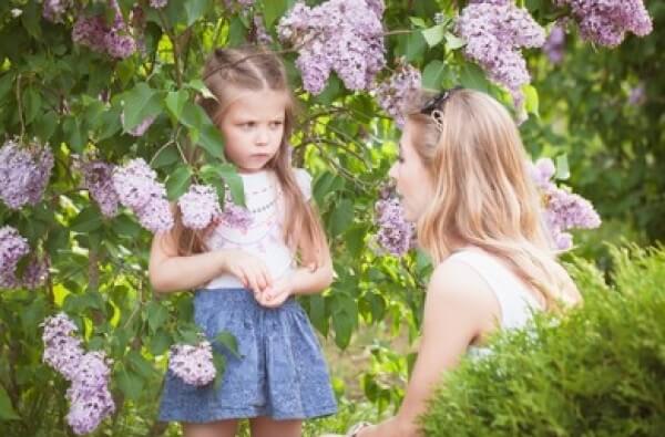 A mother correcting her daughter.