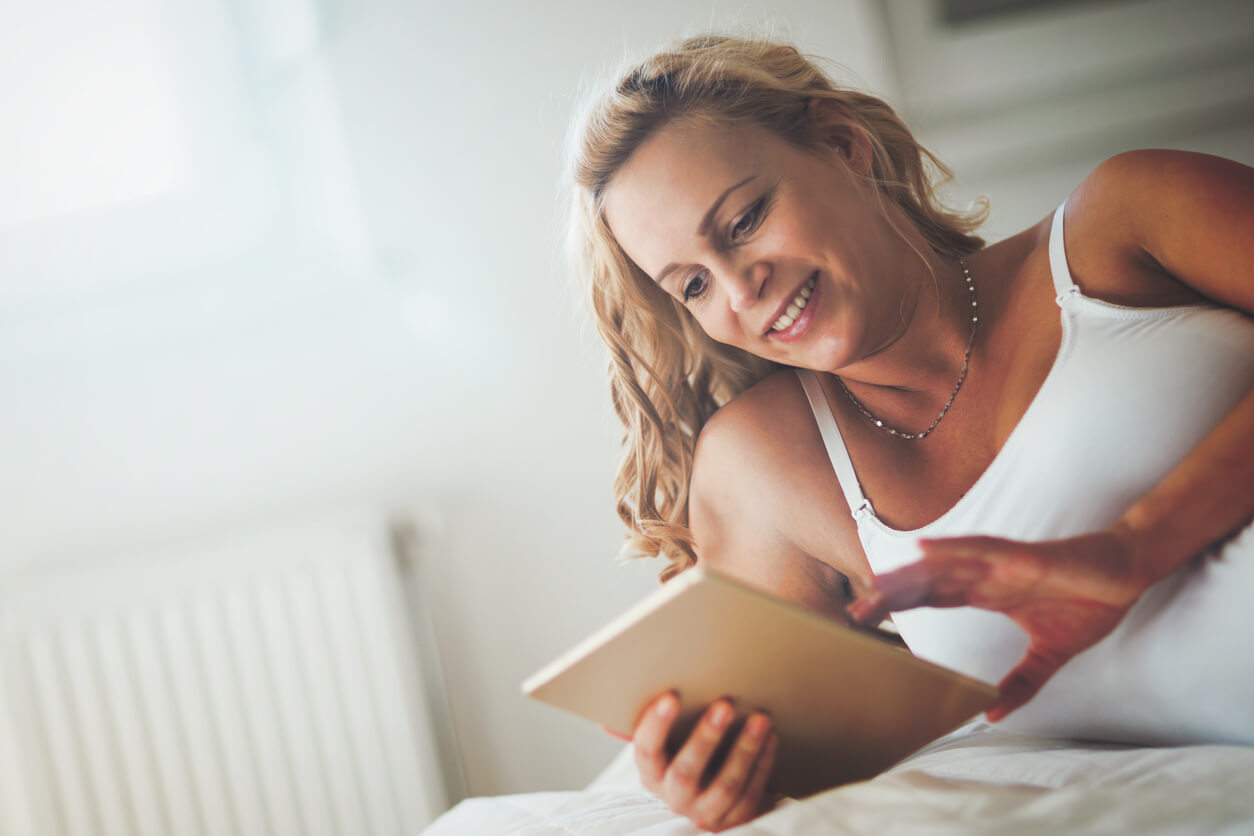A woman looking at a list of baby names.