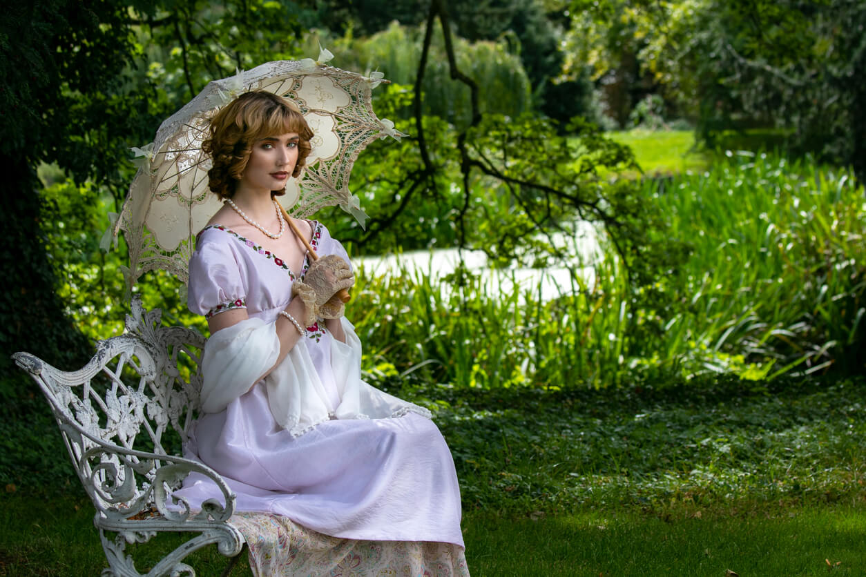 A woman sitting in a Victorian British Garden.