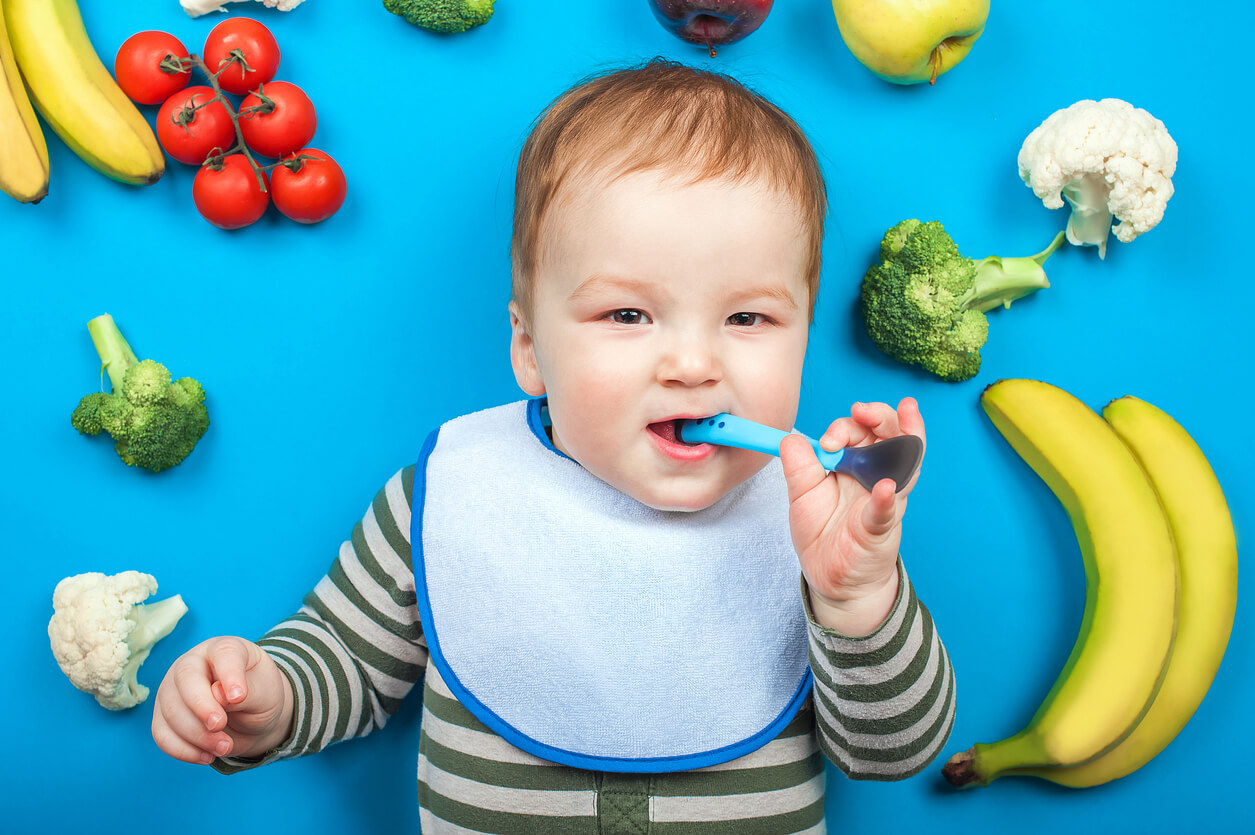 bebe acostado frutas verduras vegetales cuchara boca