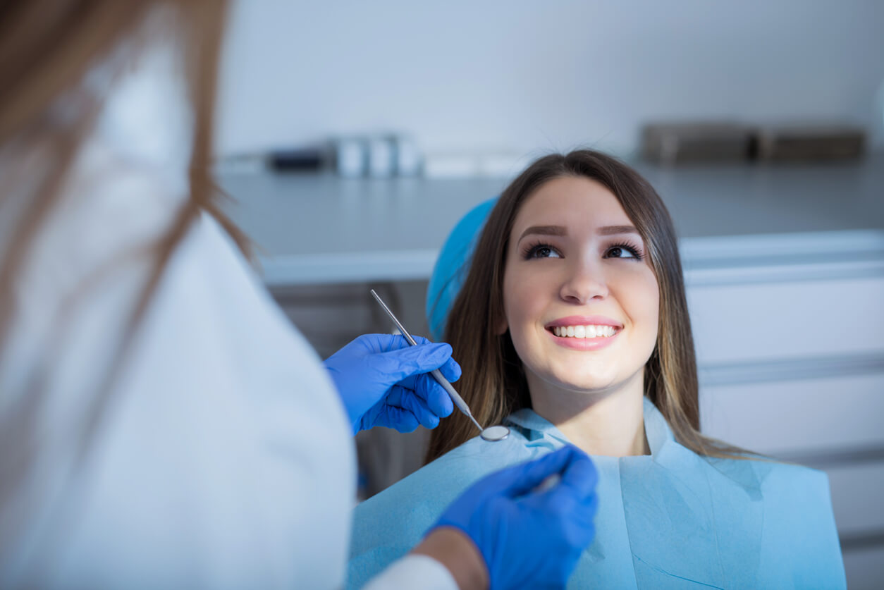 A teenage girl visiting the dentist.