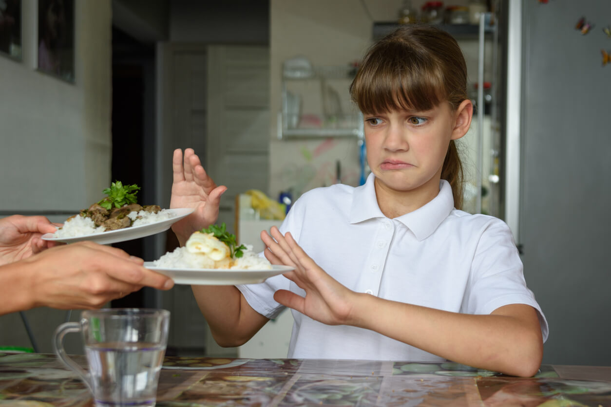 A girl refusing to eat.