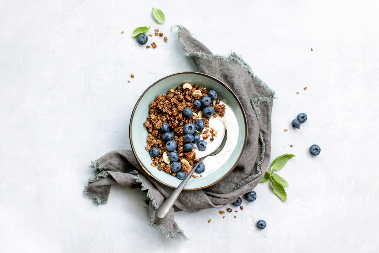 A bowl of yogurt, blueberries and granola.