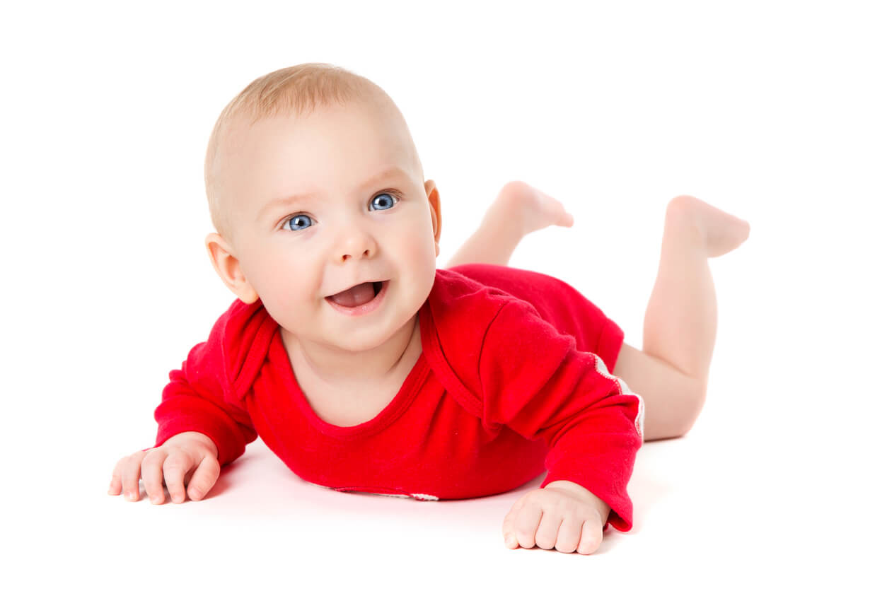A smiling baby wearing a red onesie.
