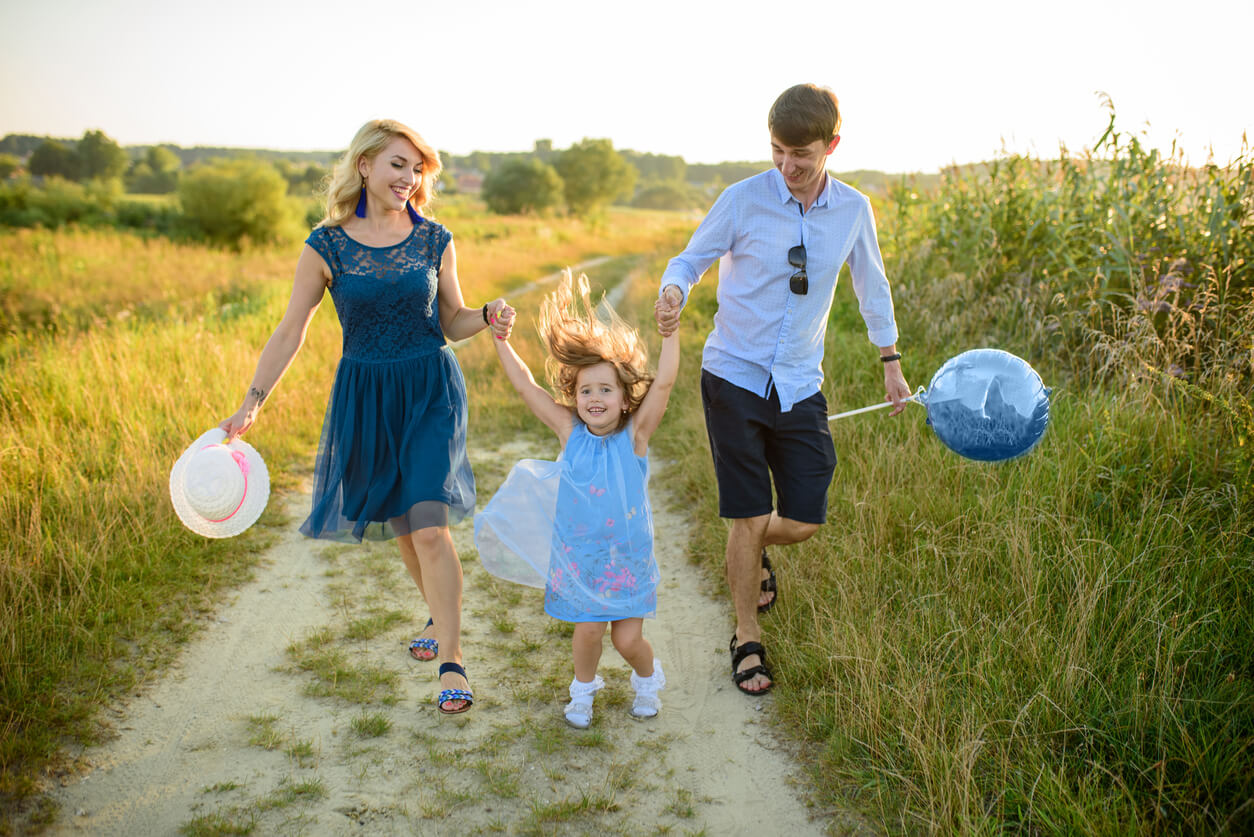 A family walking on a path in the country.