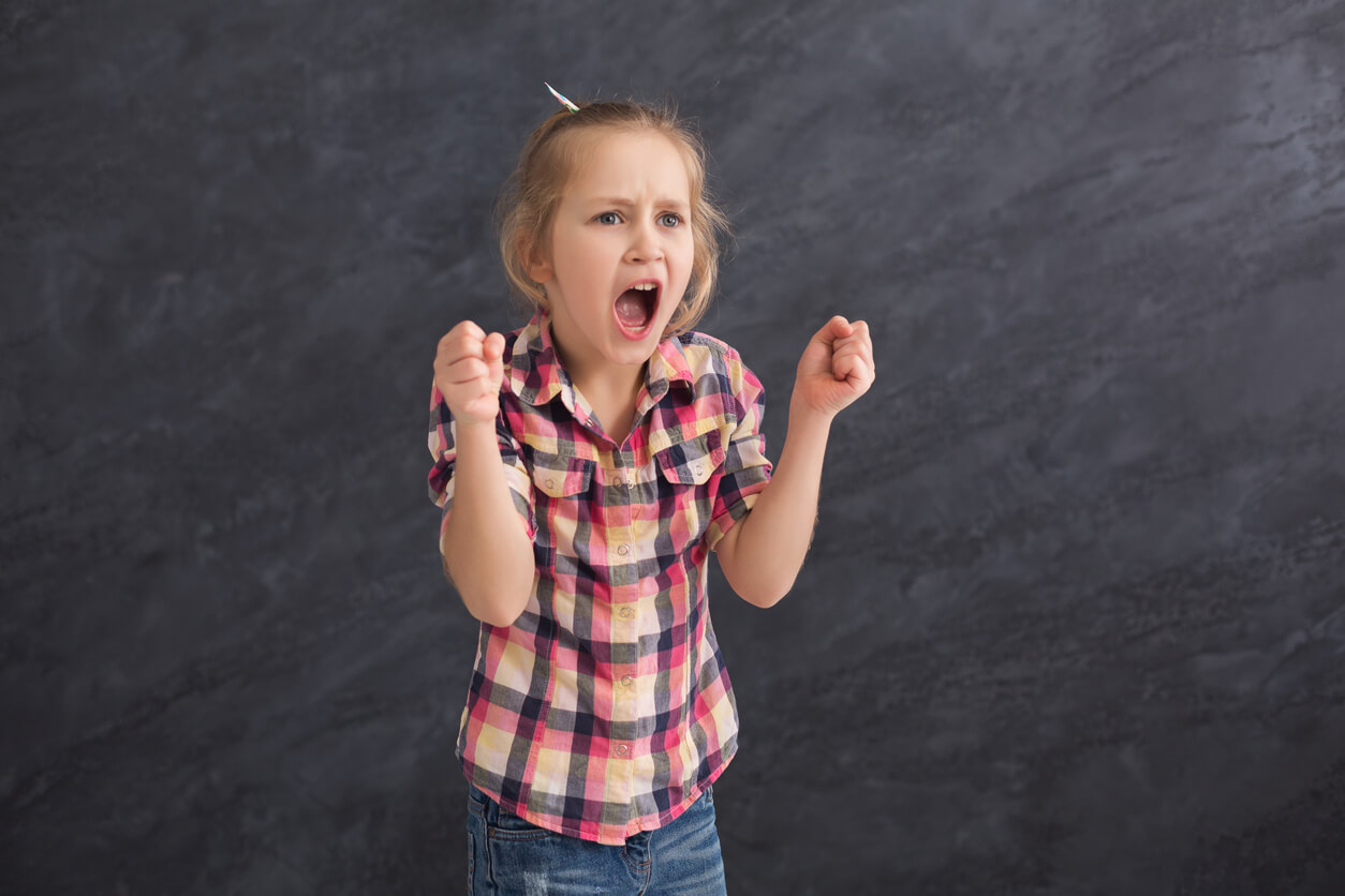 A young girl who is screaming angrily.