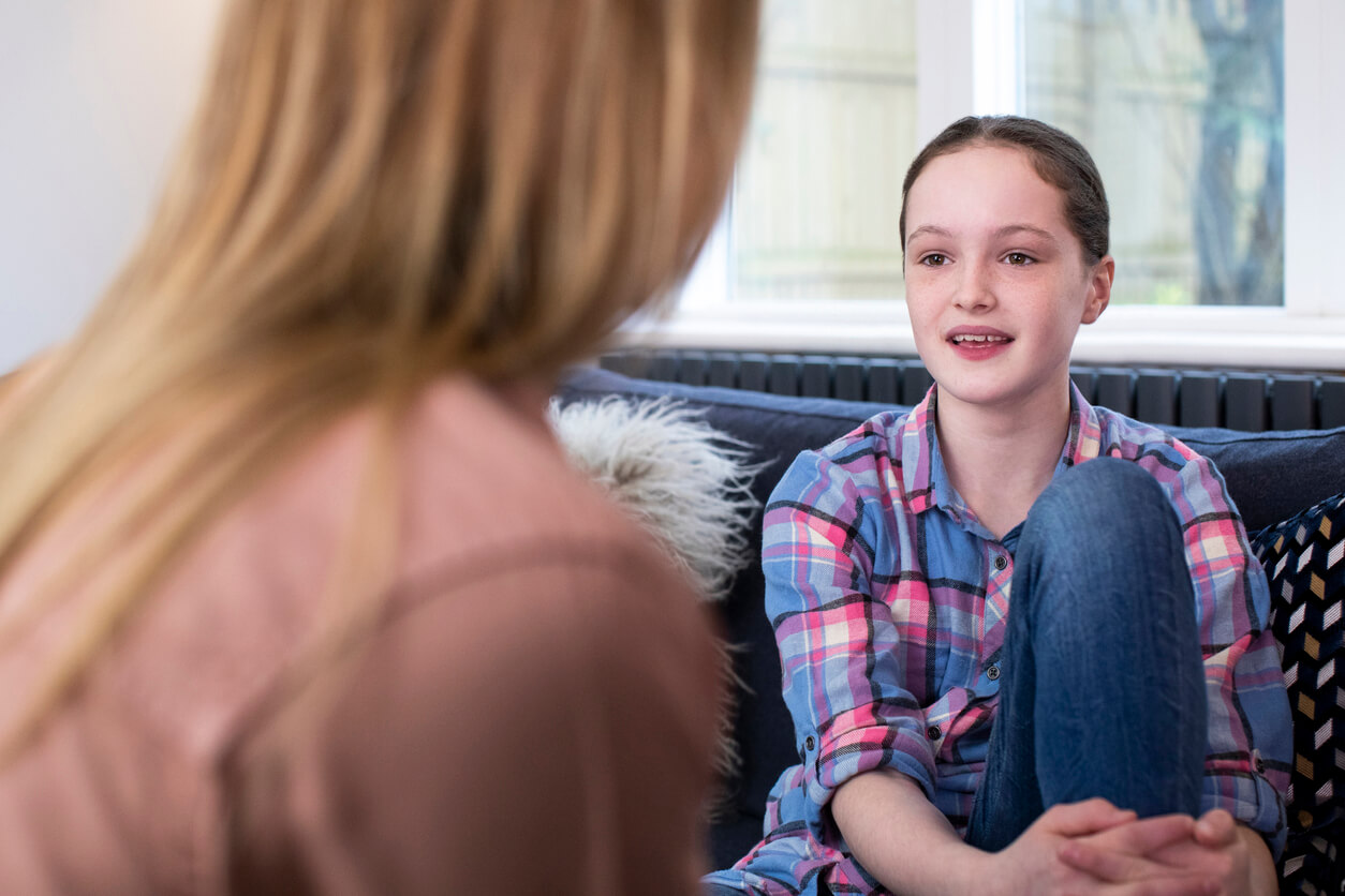 A mother having a respectful conversation with her teen daughter.