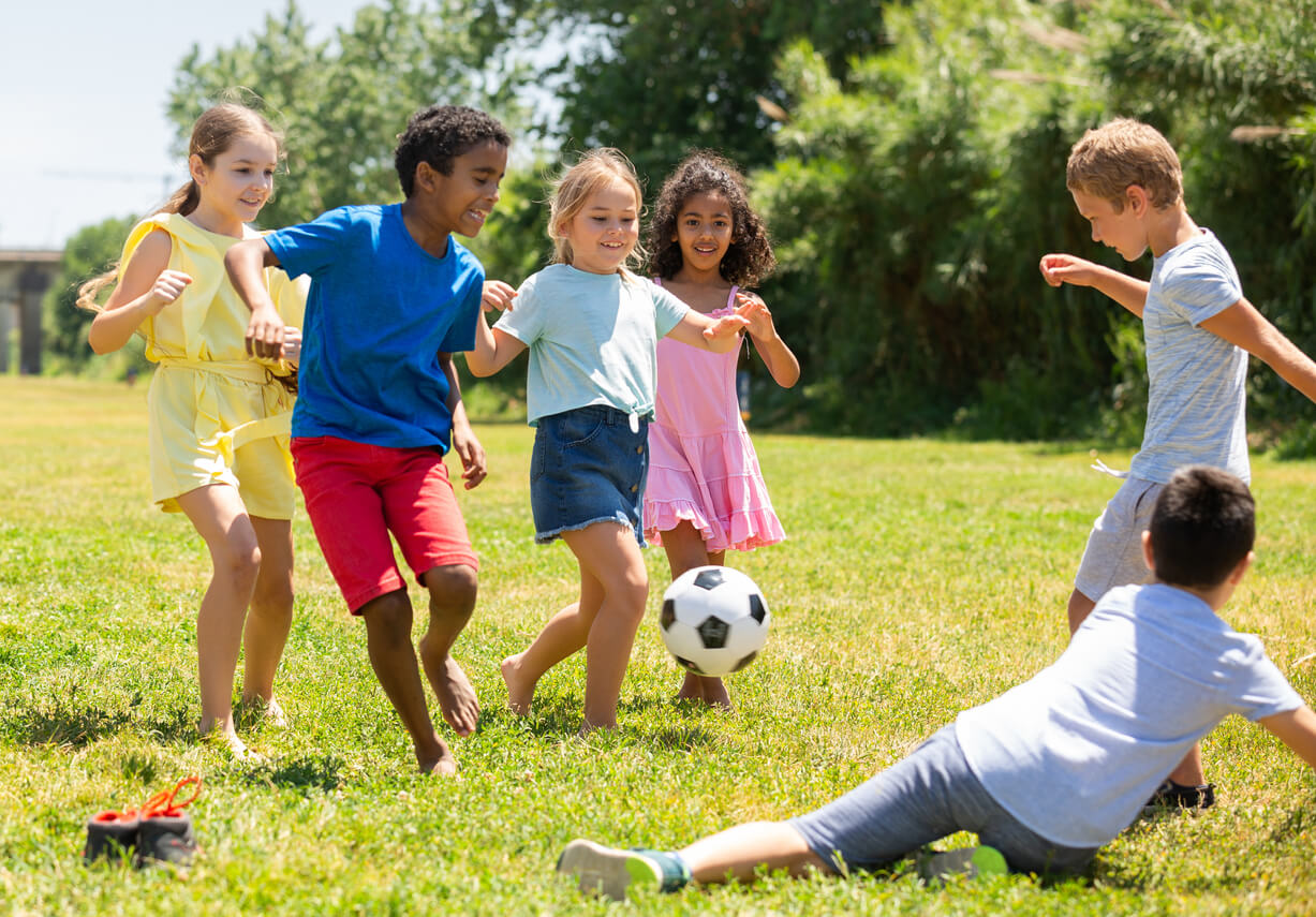 A group of boys and girls playing soccer.