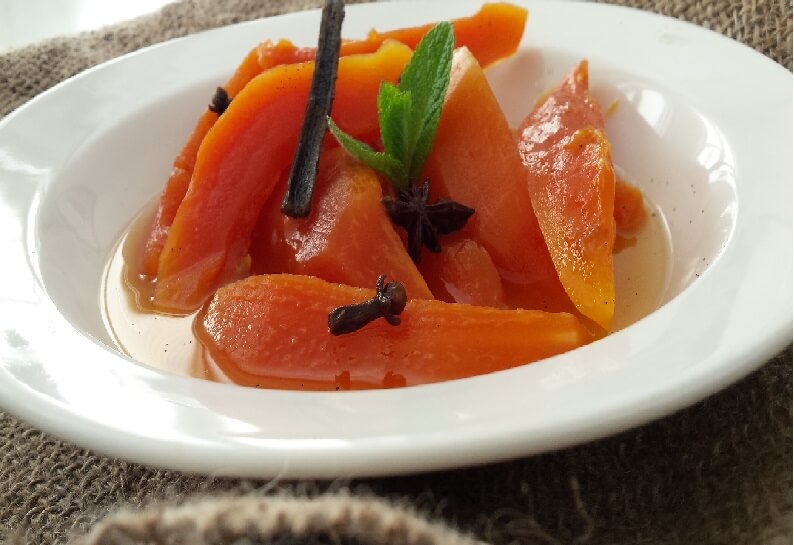Papaya and cloves in a bowl.