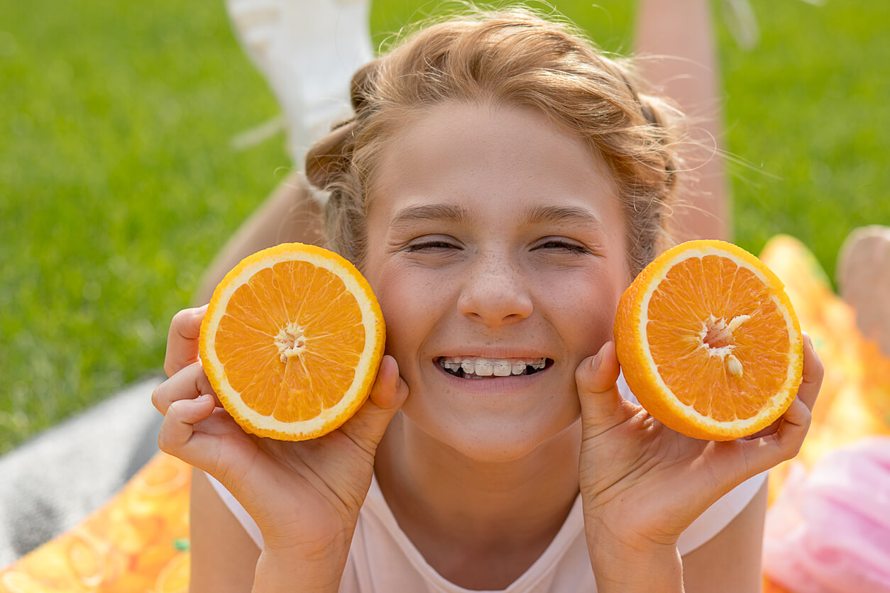 fille avec des accolades accolades accolades détient des oranges