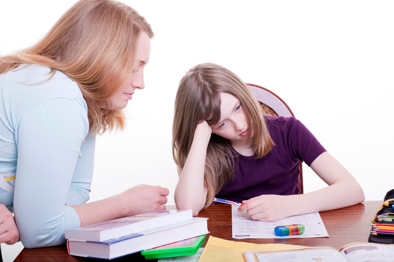 A preteen girl having a hard time with her homework.