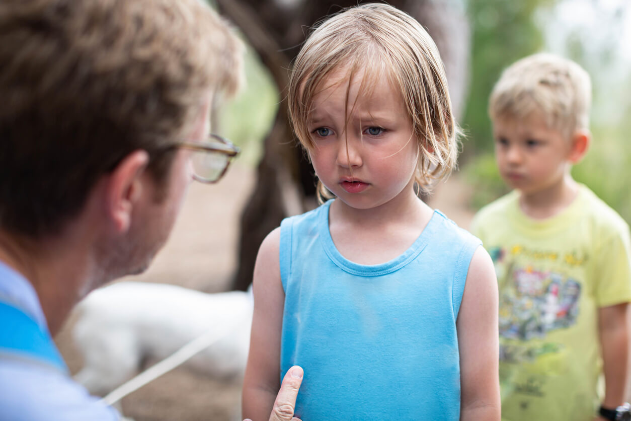 A man talking to a child that's gotten into a fight.