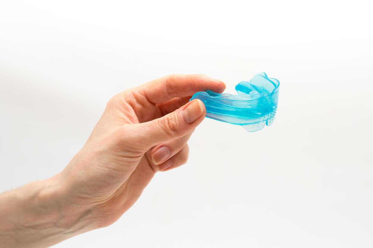 A person holding a Myobrace splint.