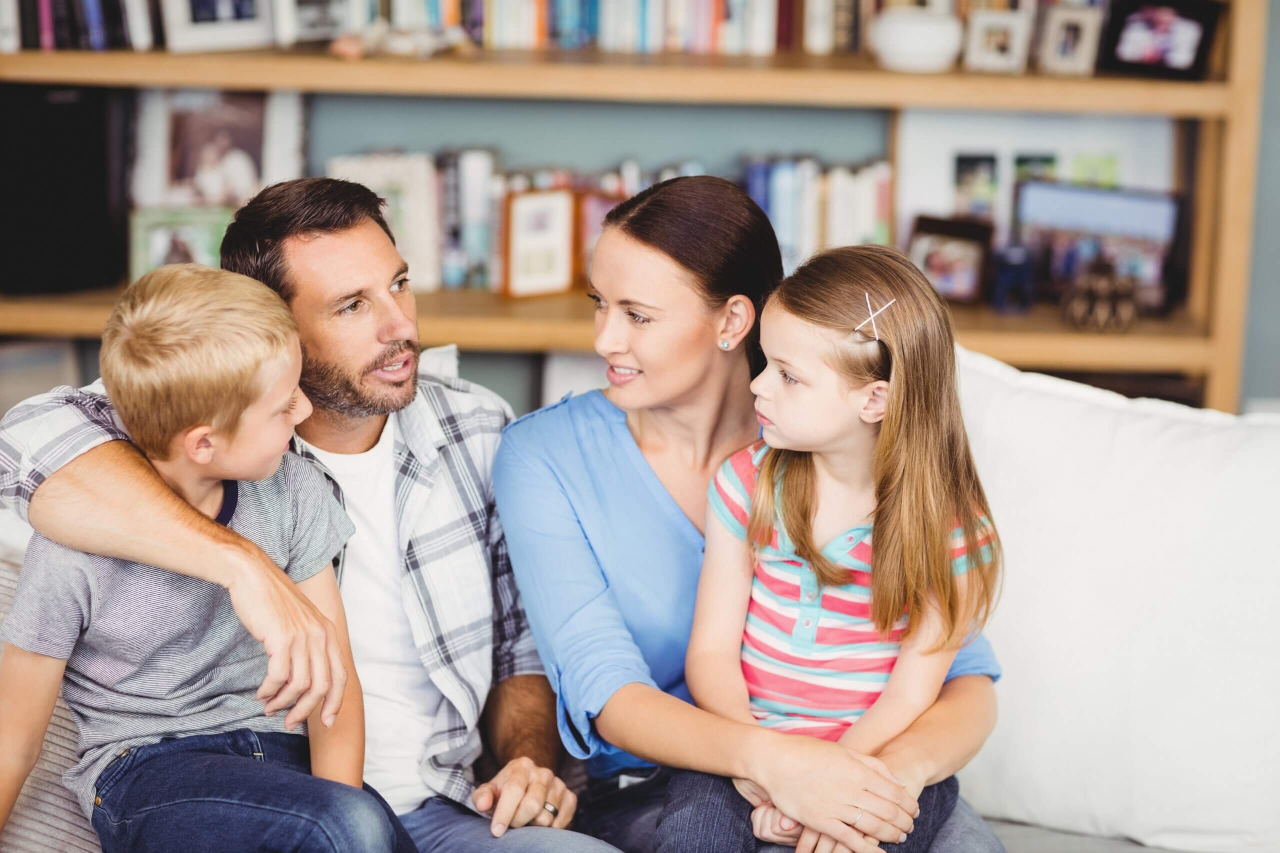 A family having a conversation on the couch.