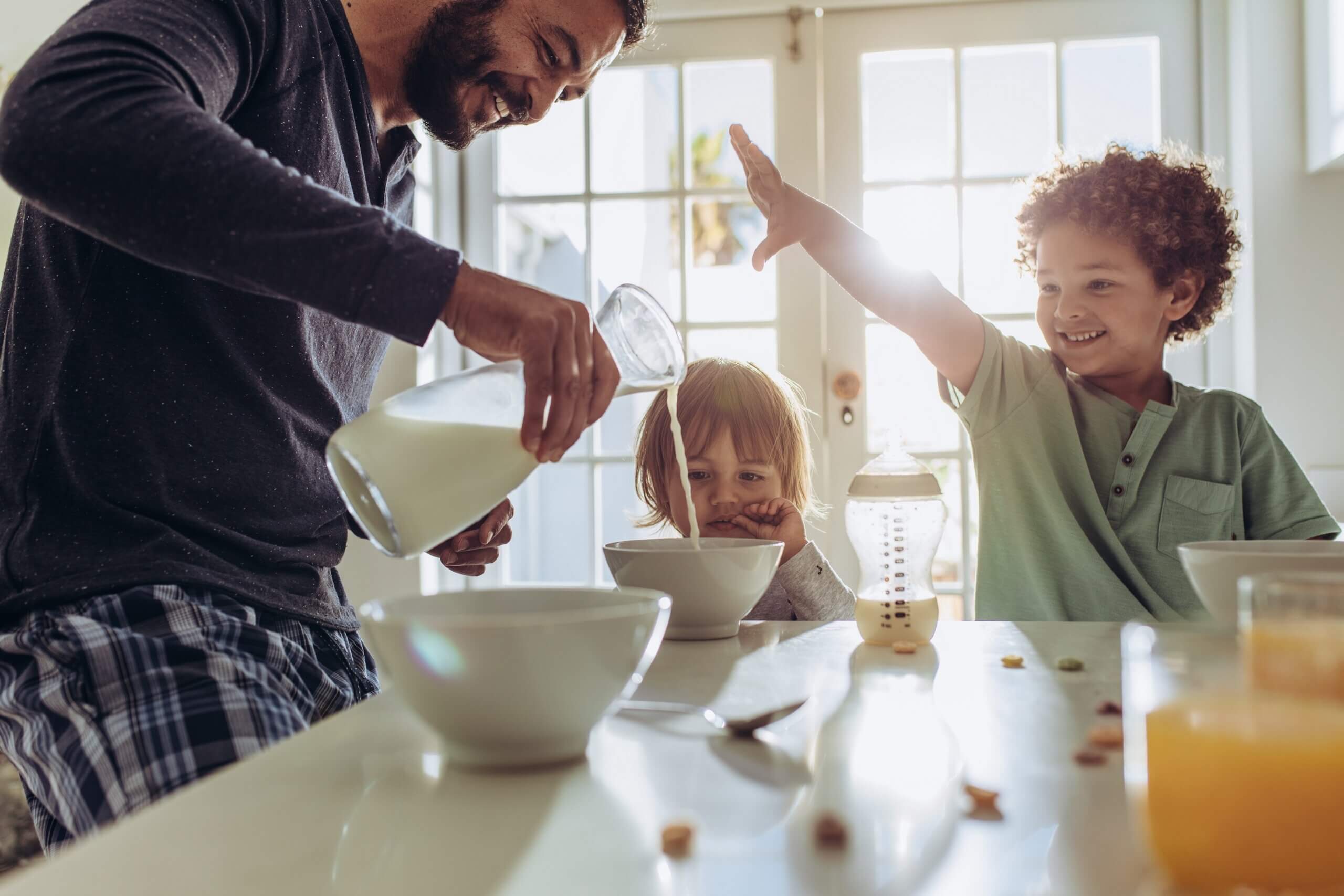 A father preparing breakfast for his chidlren.