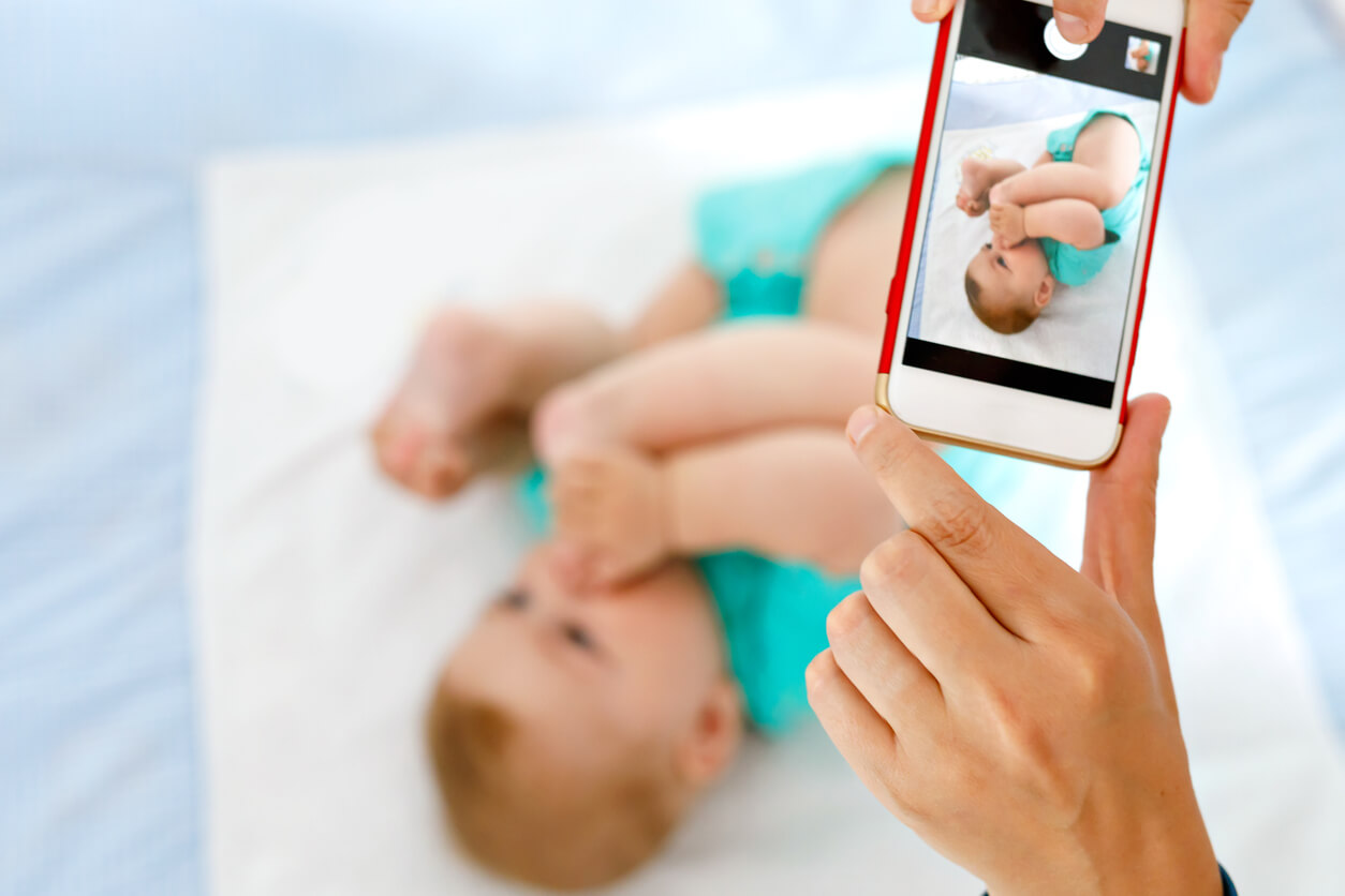 A person taking a spontanous picture of a baby.