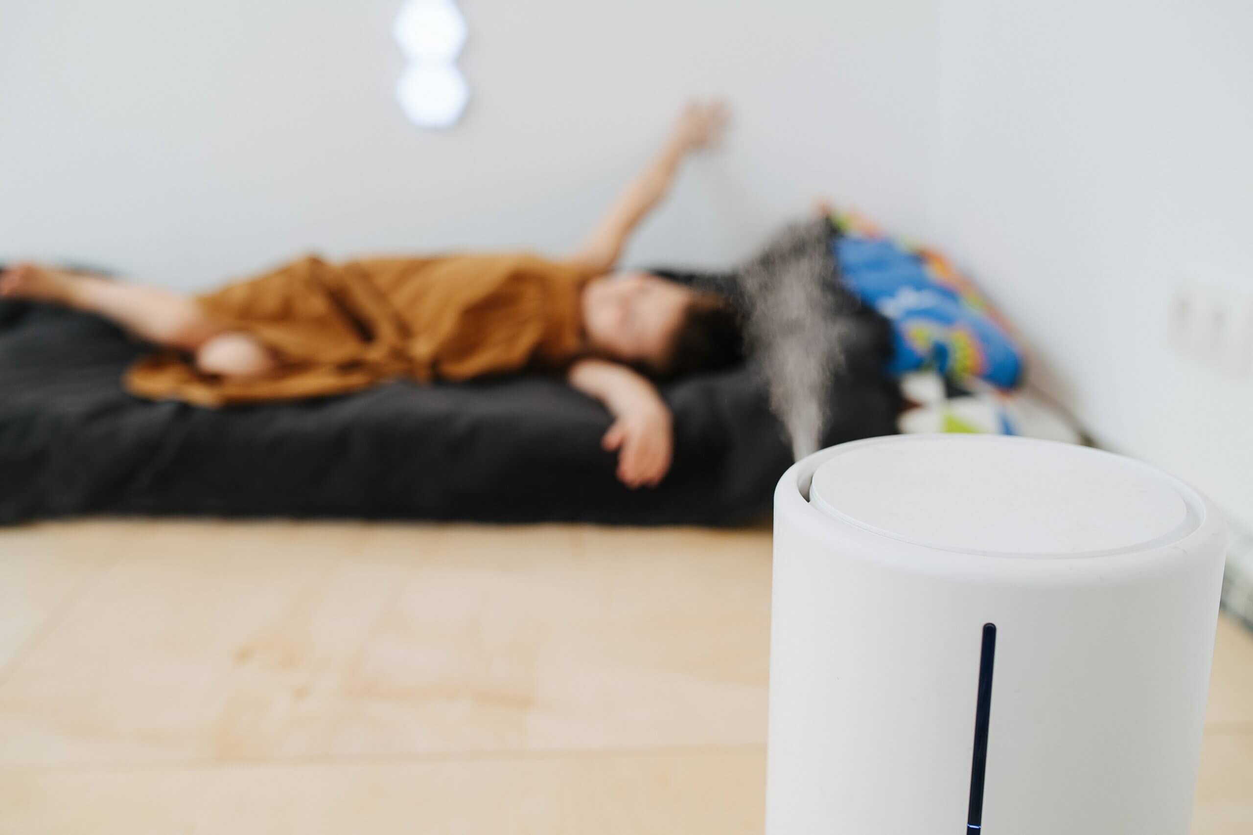A child sleeping with a humidifier.