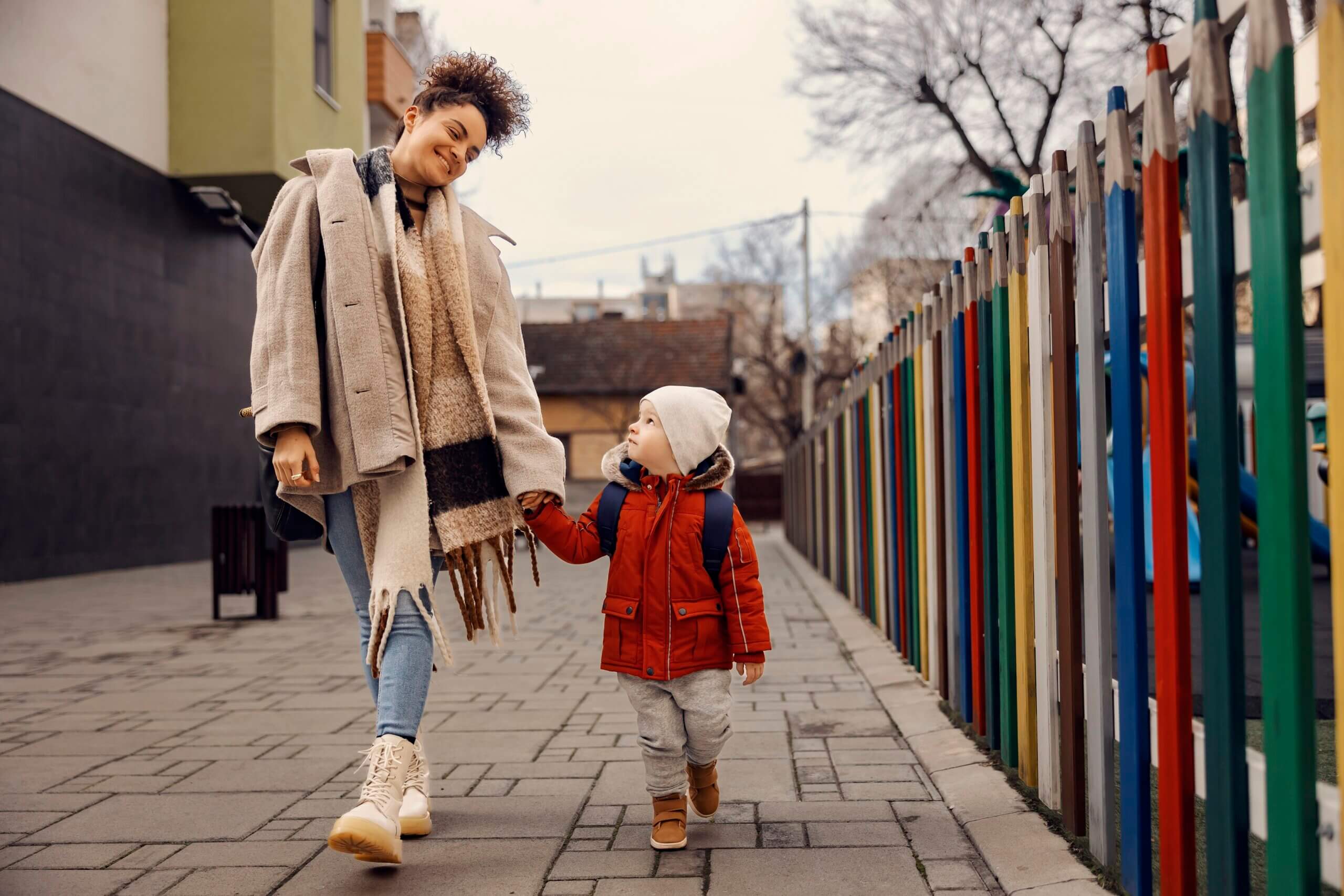 A mother walking her preschooler to school.