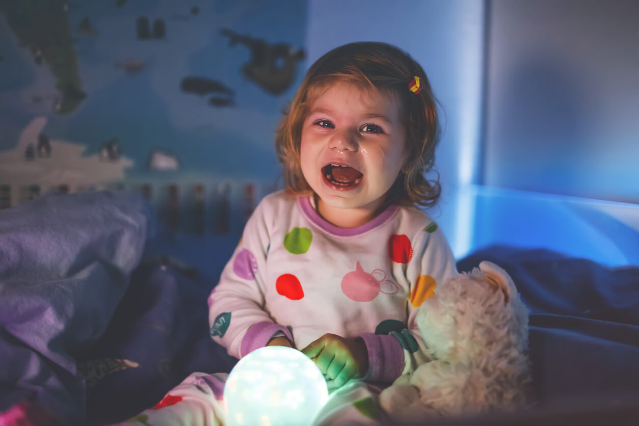 A toddler crying in her room during the night.