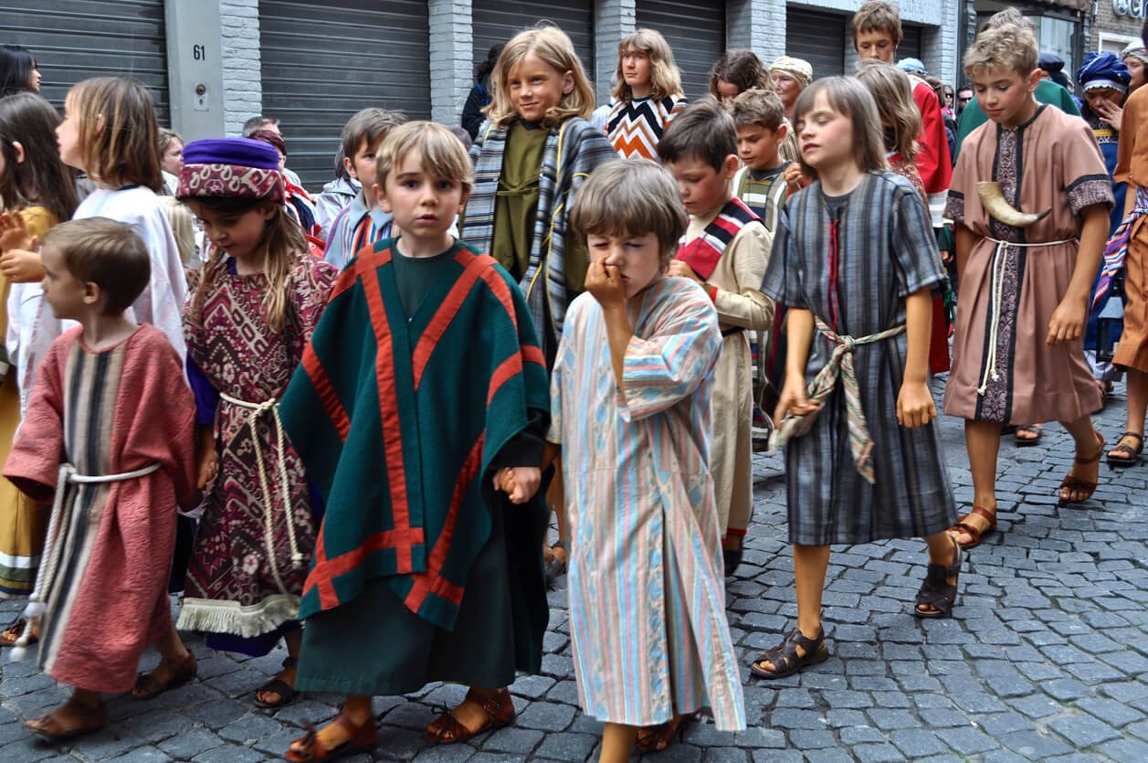 Children dressed as Biblical characters walking down the street.