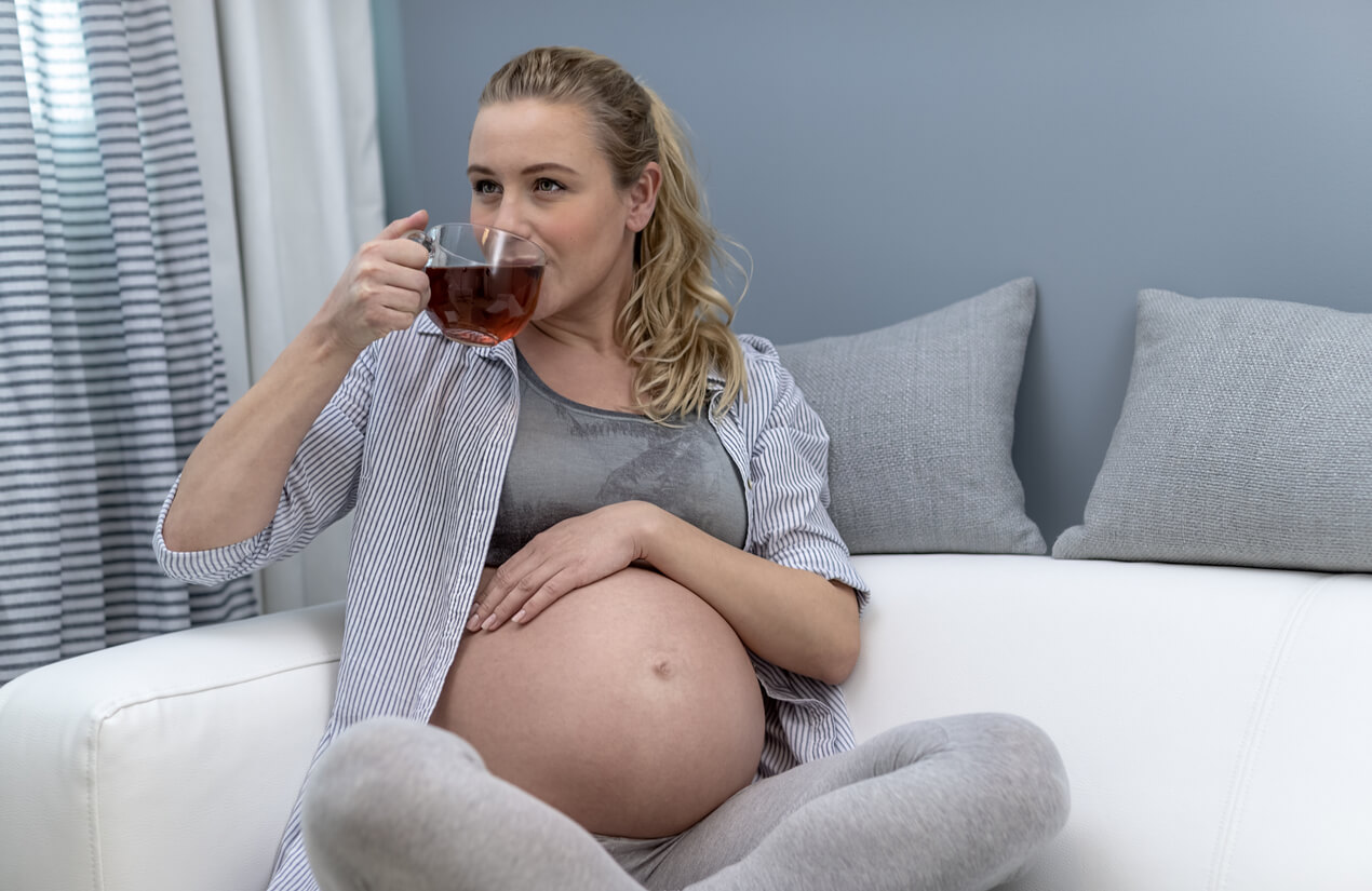 A pregnant woman drinking black tea.