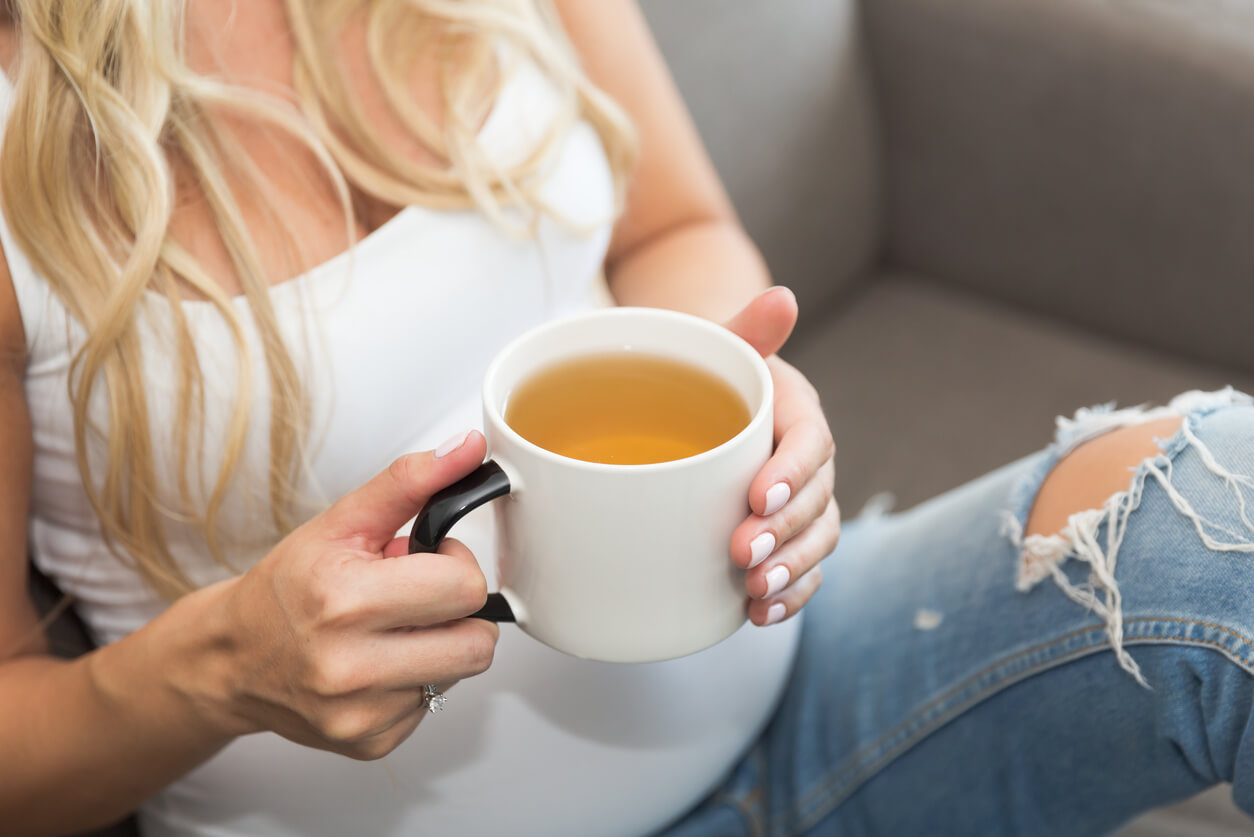 A pregnant woman drinking linden tea.