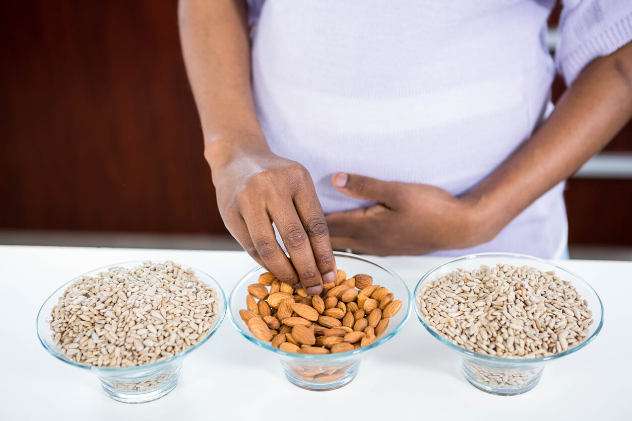A pregnant woman eating seeds and nuts.