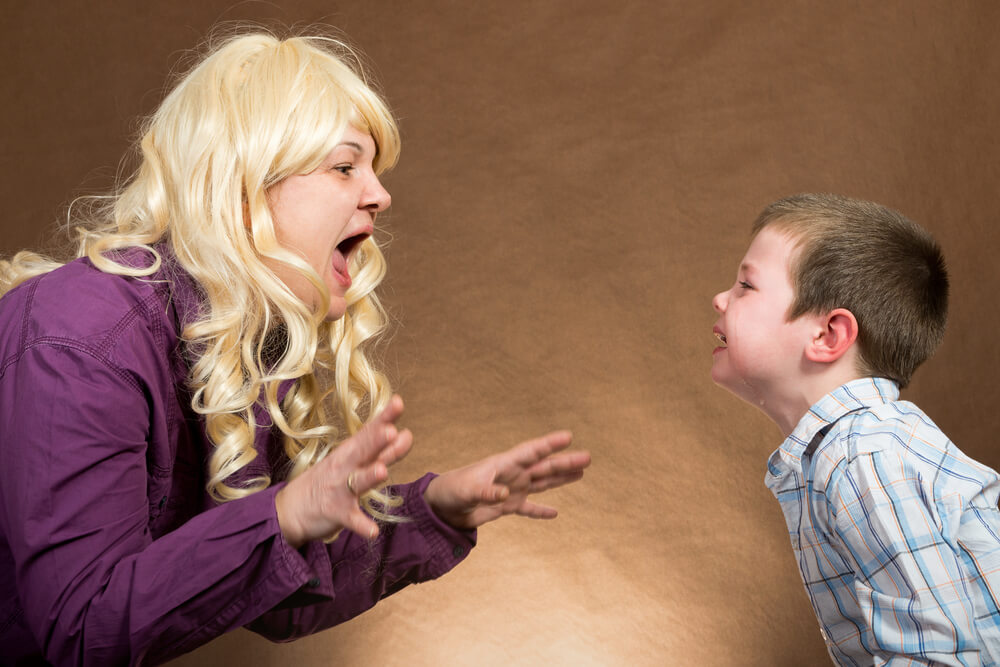 A mother yelling at her child, who's crying.