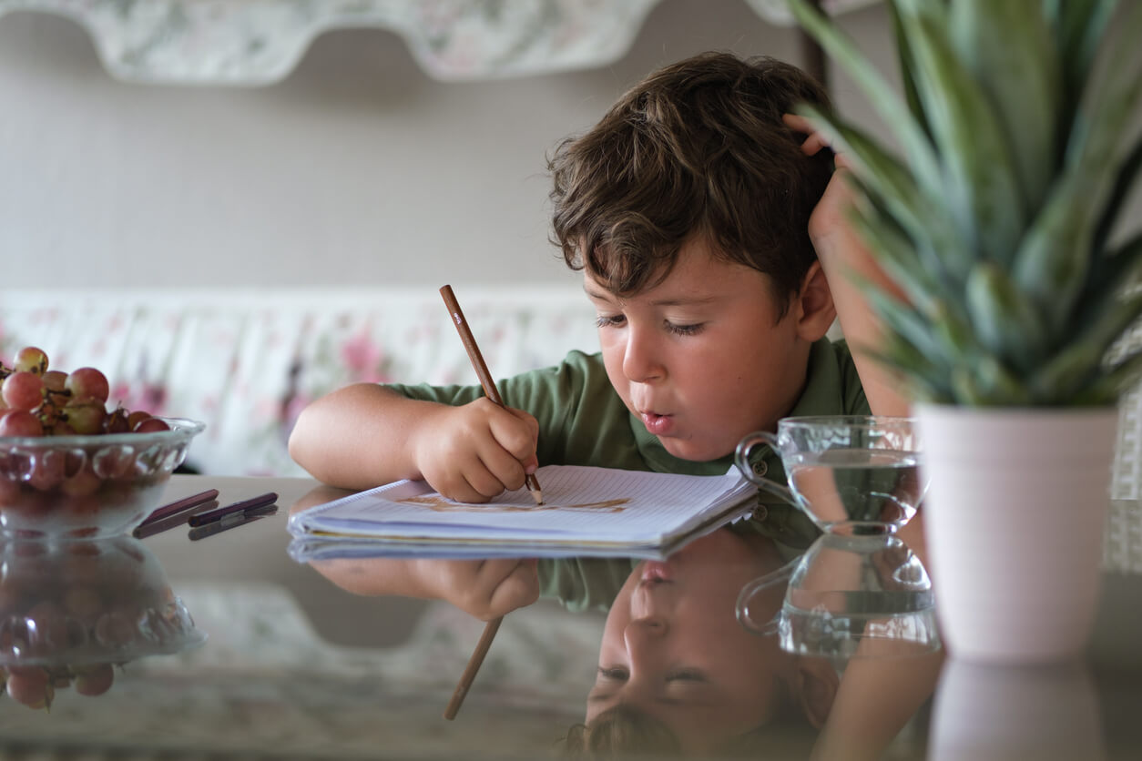 A child doing homework at the table.