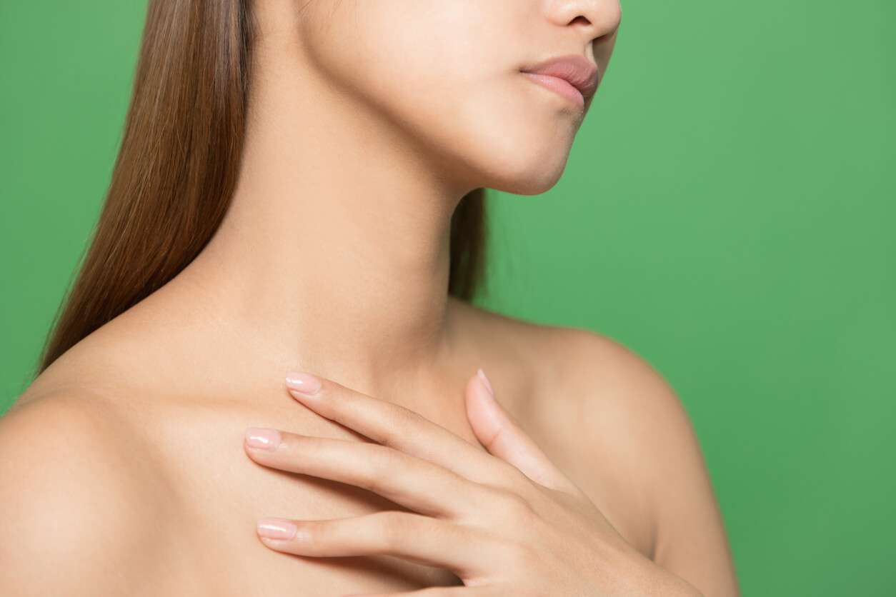 A woman touching her chest.