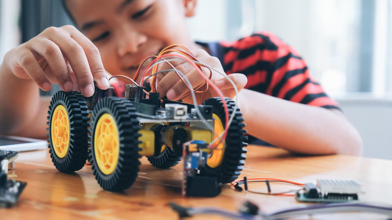 A child putting together an electric toy car.