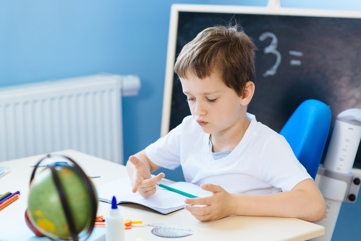 A young child doing geometry.