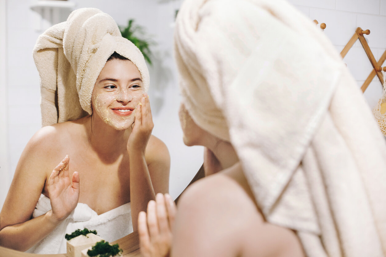 A woman cleansing her face.
