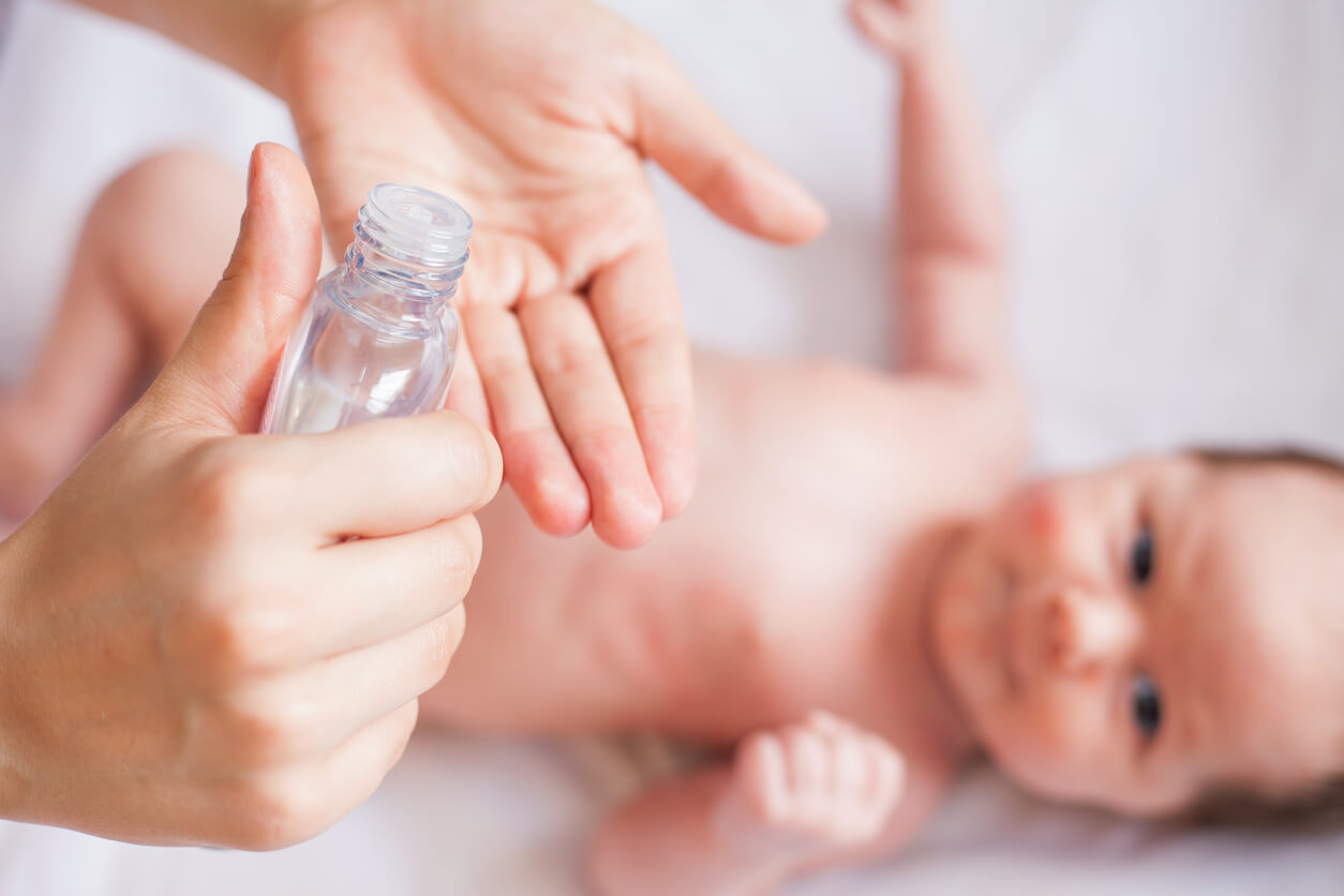 Een baby wordt ingesmeerd met babyolie