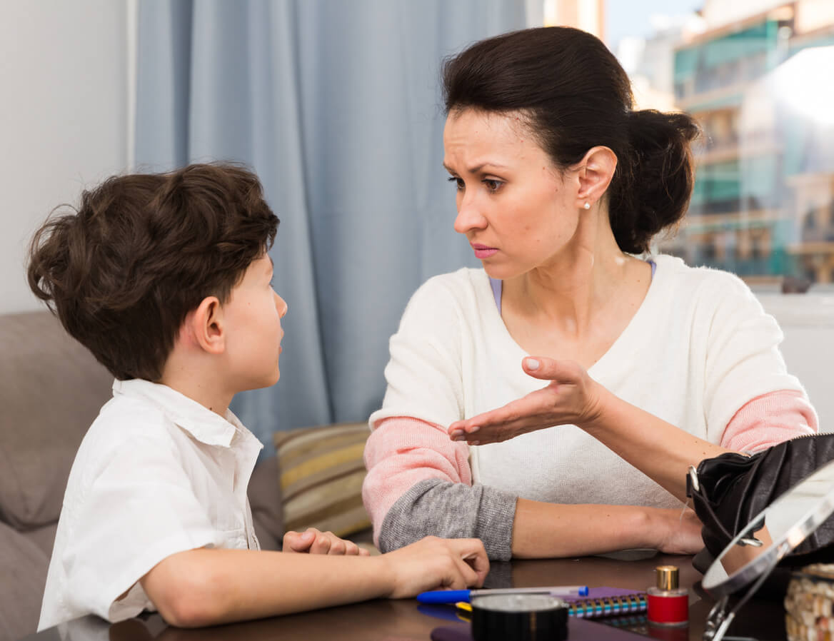 A mother having a serious conversation with her young son.