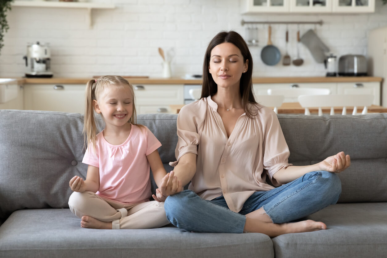 A mother and daughter practicing conscious breathing.