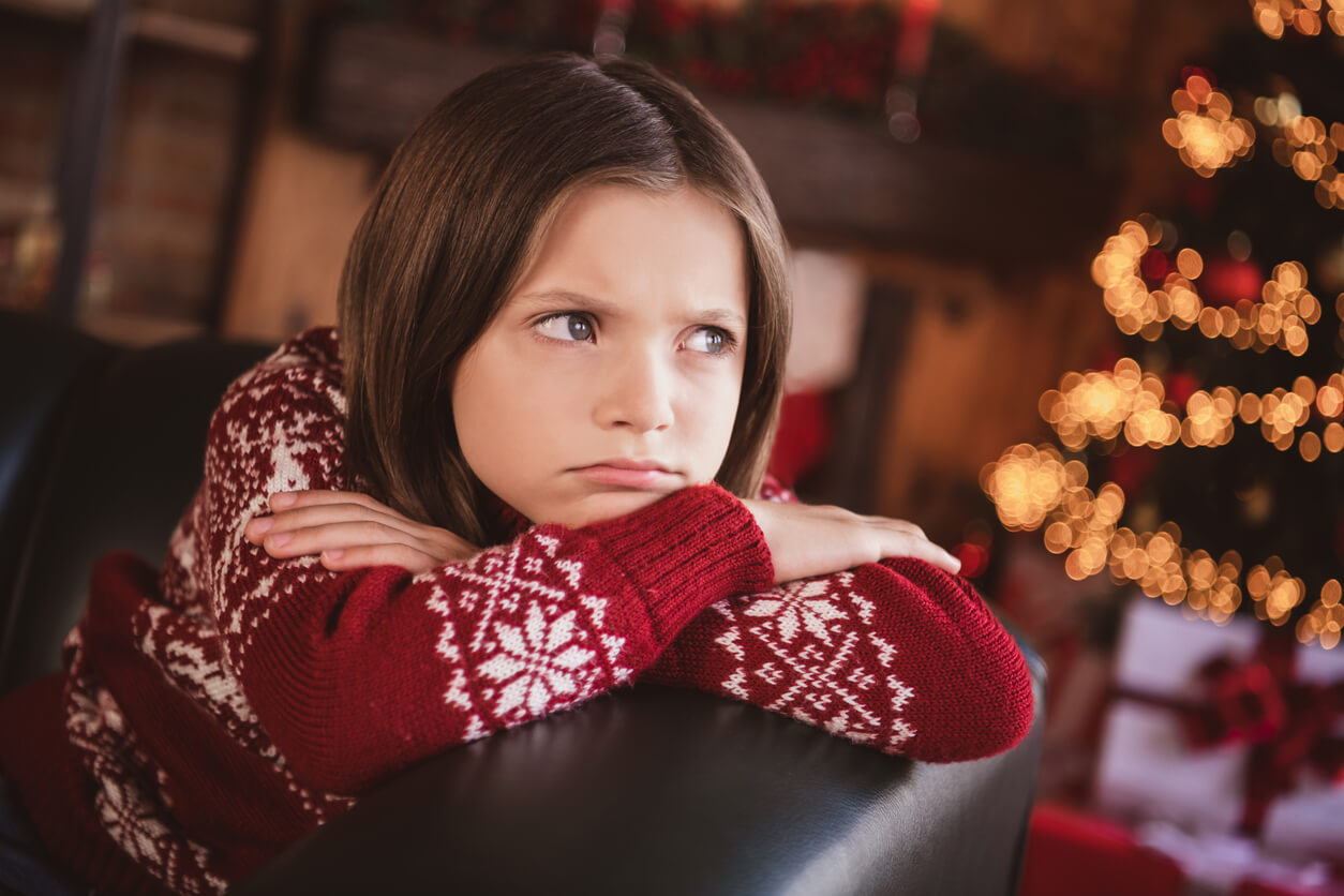 A young girl looking sad during Christmas.