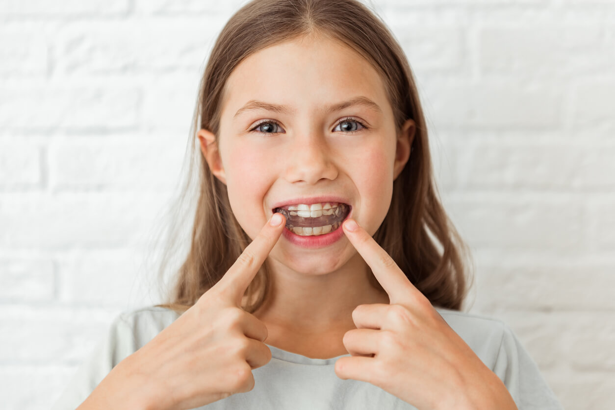 A child with an orthodontic appliance.