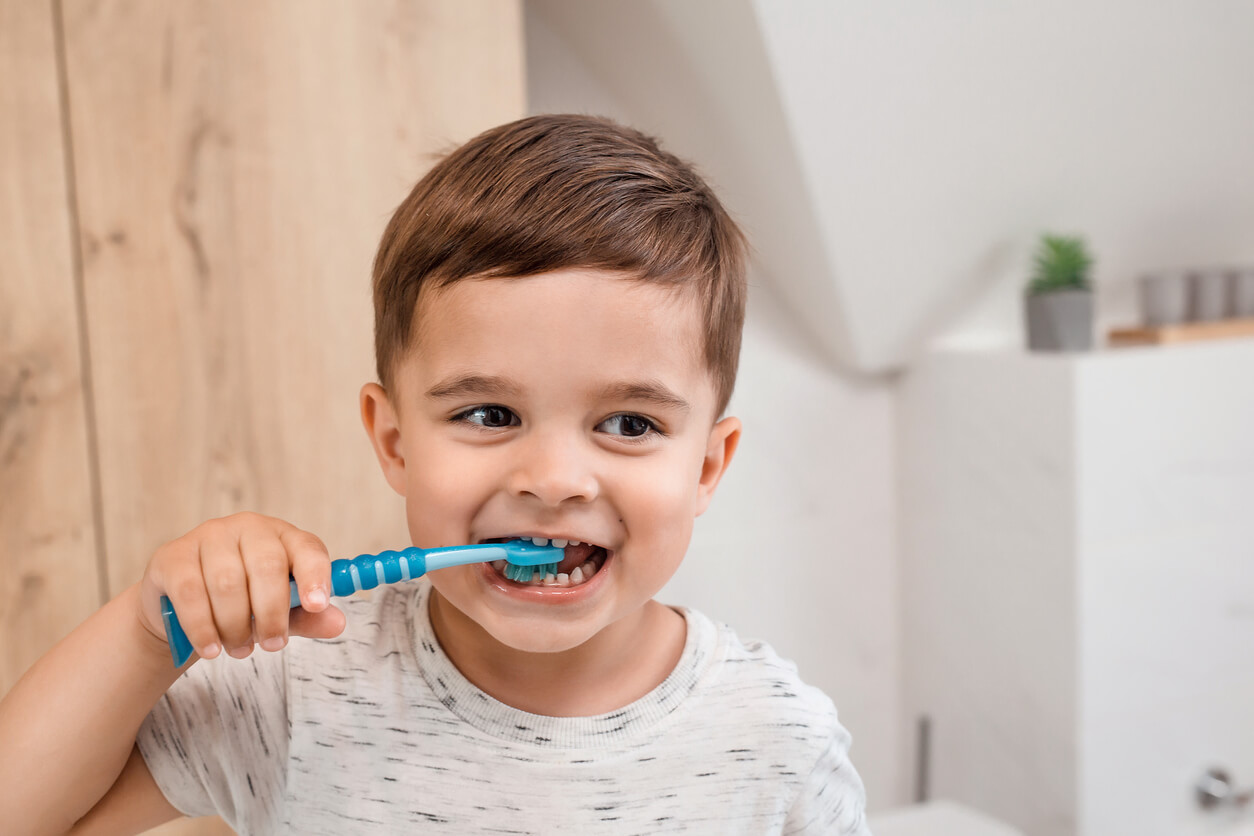 A small boy brushing his teeth.