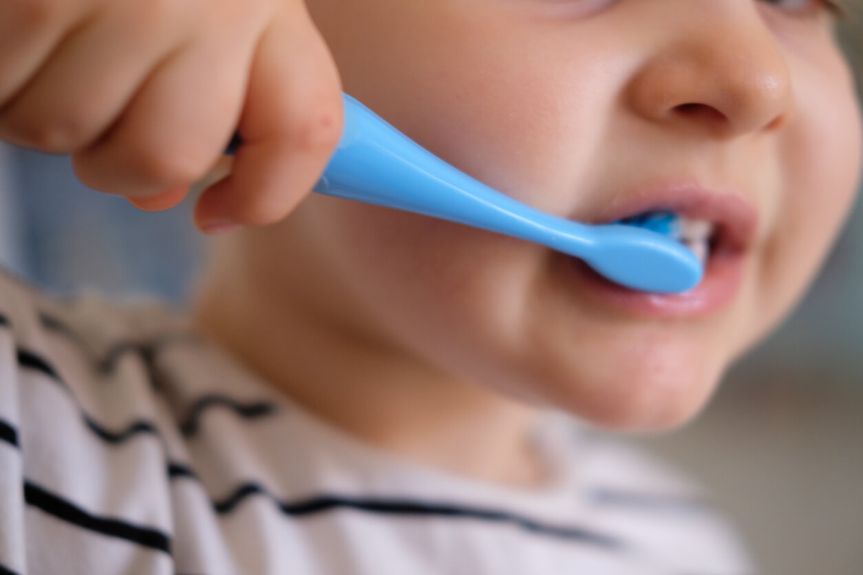 A toddler brushing his teeth.