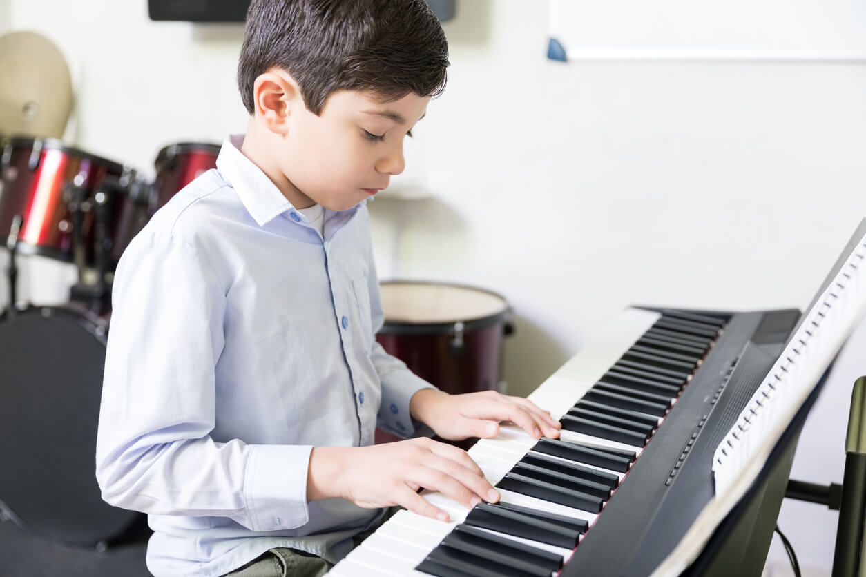 A young boy playing the keyboard.
