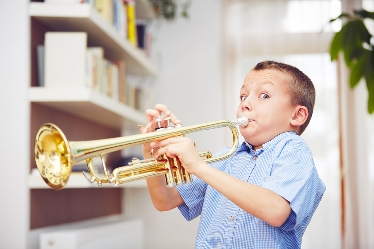 A young boy playing the trumpet.