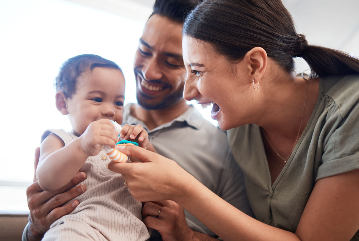 Children playing happily with their baby.